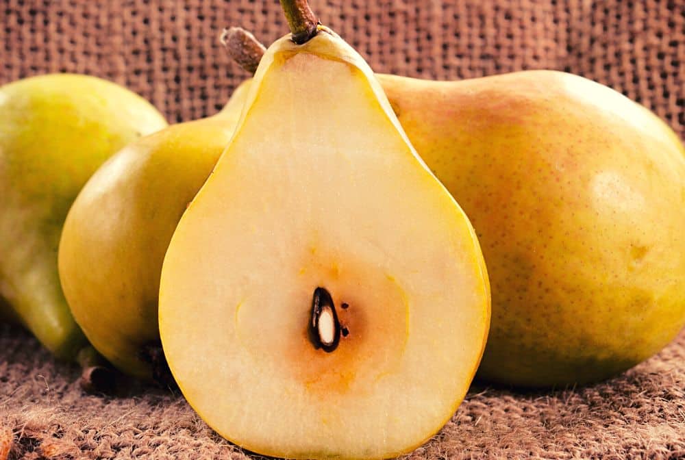 Pears and one cut in half with seeds